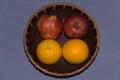 Isolated background tasty orange tangerines and red apples fruit in a bowl close up Royalty Free Stock Photo