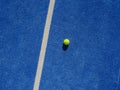 Isolated ball on a blue paddle tennis court, drone aerial view Royalty Free Stock Photo