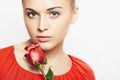 Isolated beautiful woman with flowers. girl and flower. beautiful blond girl in red dress. close-up portrait. Red rose