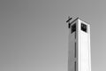 Isolated bell tower of a modern church with crucifix - Minimal architecture