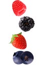 Falling raspberry, strawberry and blueberry fruits isolated on w