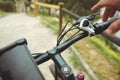 Close-up hand of a man adjusting the bicycle brakes while cycling in the mountains. Man in electric bike, gently Royalty Free Stock Photo