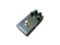 Isolated black metallic glitter distortion stompbox electric guitar effect for studio and stage performed on white background