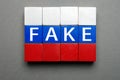 Lie media Russia news poster design. Isolated block letters wood word fake in Russian flag colors cubes. Wooden cubes Royalty Free Stock Photo