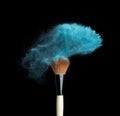 Isolated blue make-up powder with brush on black Royalty Free Stock Photo