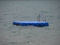 Isolated Blue Ponton Swimming Platform on Stormy Water Royalty Free Stock Photo