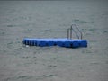 Isolated Blue Ponton Swimming Platform on Stormy Water