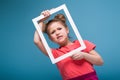 Beautiful cute little girl in pink dress holds picture frame Royalty Free Stock Photo