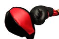 Right hand with black and red boxing grove punch to the upholstering black and red punching ball bag until the tilt. Royalty Free Stock Photo