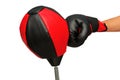 Right hand with black and red boxing grove punch to the upholstering black and red punching ball bag until the tilt. Royalty Free Stock Photo