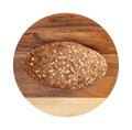 Isolated bread with seeds and flakes on wooden round cutting board on white background. Royalty Free Stock Photo