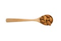 Isolated of brown fresh almonds nut inside wooden spoon on white background.clipping path