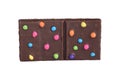 Isolated brownie square with colorful candy pieces Royalty Free Stock Photo