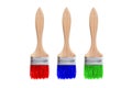 Isolated brushes. Three brushes with red, blue and green paint are isolated on a white background. Royalty Free Stock Photo