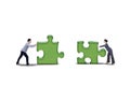 Isolated business partner putting together two puzzle Royalty Free Stock Photo