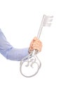 Isolated businessman holding a silver key in his hand. Royalty Free Stock Photo