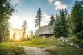 Isolated Cabin in Mountains Surrounded by Deep Forrest, sunset in background with sunrays. Slovakia Tatra Mountains