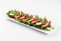 Isolated caprese salad with mozzarella and tomato