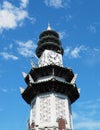 Chinese pagoda clock tower soars in blue sky Royalty Free Stock Photo