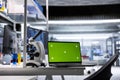 Isolated chroma key display on laptop in empty biolab setup with microscope Royalty Free Stock Photo