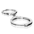 Isolated chrome Handcuffs on an Unmarked Light Background With Reflection