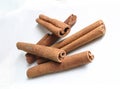 Isolated cinnamon sticks lying on white dish