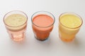 Isolated citrus juice. Three glasses with orange, grapefruit and lemon juice isolated on white background