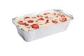 Isolated close corner view of a Russian zapekanka strawberry pudding cottage ice cream cheese cake in a foil baking pan on a white