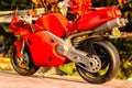 A isolated closeup red toy motorcycle with warm colors- back view Royalty Free Stock Photo