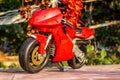 A isolated closeup red toy motorcycle with warm colors- front view Royalty Free Stock Photo