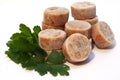 Isolated closeup shot of cut-up circular frozen fish sauce with parsley Royalty Free Stock Photo