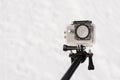 Isolated closeup shot of a small portable action camera on a stick on a white background Royalty Free Stock Photo