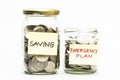 Isolated coins in jar with emergency plan and saving label. Royalty Free Stock Photo