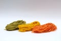 Isolated colored spaghetti nests on a white background