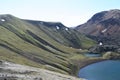  Crater lake at Laki volcano with black lava sourrounded by rugged mountains, Iceland