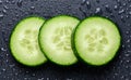 Isolated cucumber slices. Pieces of fresh cucumber isolated on black background Royalty Free Stock Photo