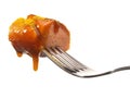 Isolated Curry Sausage on a Fork with Sauce