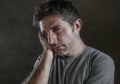 Isolated dark background portrait of 30s to 40s sad and depressed man looking thoughtful and worried suffering depression problem Royalty Free Stock Photo