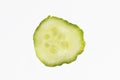 Isolated detailed close up macro shot of a thin slice of a bright green cucumber on a white background Royalty Free Stock Photo