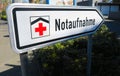 Isolated direction sign with red cross for hospital emergency department german word: Notaufnahme - Germany