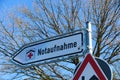 Isolated direction sign with red cross for hospital emergency department german word: Notaufnahme - Germany