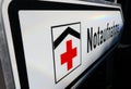 Isolated direction sign with red cross for hospital emergency department german word: Notaufnahme - Germany