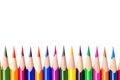 Isolated down border. Coloured wooden pencils. Close-up. Royalty Free Stock Photo