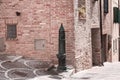 An isolated drinking fountain in the street of a medieval italian village Italy, Europe