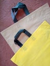 Isolated eco friendly Yellow black and brown bags with black handle