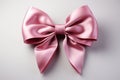 Isolated elegance pink ribbon adorned with bow, set against a clean white backdrop