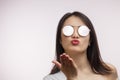 Isolated fashionable asian woman in trendy sunglasses sends a kiss Royalty Free Stock Photo