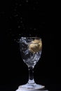 Isolated flashing glass of water with black background Royalty Free Stock Photo