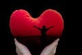 Isolated freedom silhouette women in red heart on black background in hands