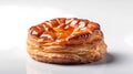 Isolated fresh, ruddy pastry lies on a white glossy surface